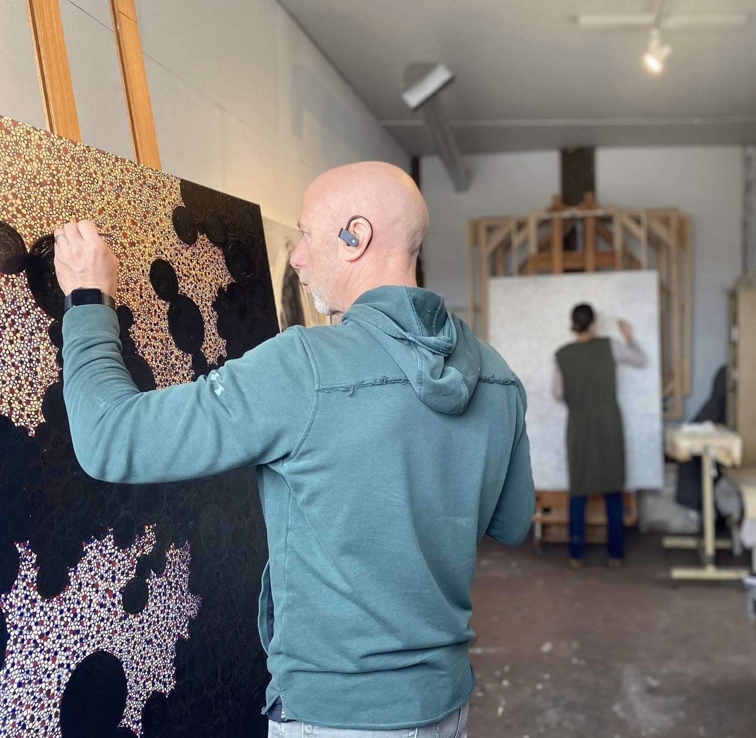 Simon Aitchison painting in the studio